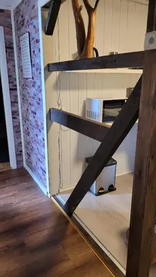 a shelf in a room with a brick wall at Apartment Fjordblick in Leikanger