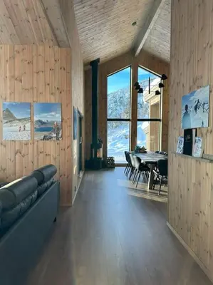 a living room with a couch and a table at Ny koselig hytte ved Sogn skisenter in Hafslo