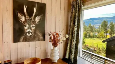 a painting of a deer on a wall next to a window at Modern cabin, great view, sunny, 2BA, 4BR in Hemsedal
