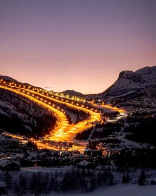 a city lit up at night in the mountains at Modern cabin, great view, sunny, 2BA, 4BR in Hemsedal