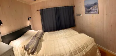 a bedroom with a bed in a room with a window at Modern cabin, great view, sunny, 2BA, 4BR in Hemsedal