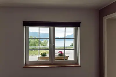 a window with two potted plants in a room at Vestre apartment in Ålesund