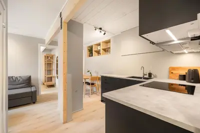 a kitchen with a sink and a counter top at Central and modern apartment in Trondheim