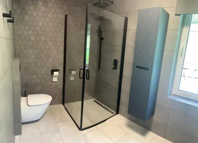 a bathroom with a shower and a toilet at Husslåttene apartments with terrace in Skei
