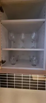 a shelf with wine glasses on it at Sokkel-leilighet med nærhet til sentrum og Hovden skiheis in Oppdal