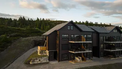an aerial view of a large black house at Storefjell Resort - Panorama apartments in Gol