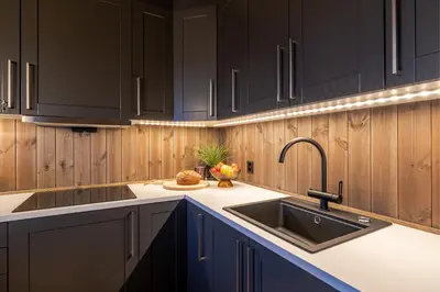 a kitchen with black cabinets and a sink at Storefjell Resort - Panorama apartments in Gol