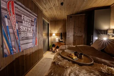 a living room with a couch and a table at Storefjell Resort - Panorama apartments in Gol