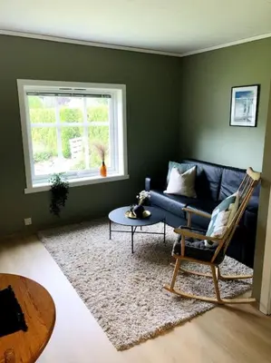 a living room with a blue couch and a table at Flat in the center of Loen in Loen
