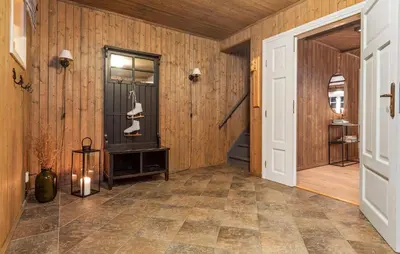 a hallway with wood paneled walls and a door at Awesome Home In Svingvoll With Sauna in Svingvoll