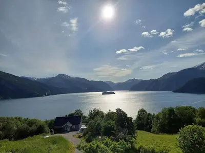 a house on the shore of a large lake at Norwegian Fjords Time Out in Stranda
