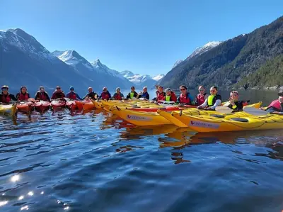 a group of people in kayaks on the water at Norwegian Fjords Time Out in Stranda