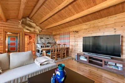 a living room with a large flat screen tv at Charming cabin retreat by the coast in Midsund in Midsund