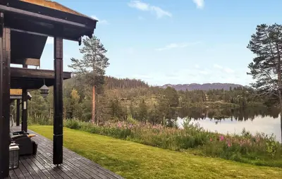a house with a view of a lake at Nice Home In Vinje With House Sea View in Trovatn
