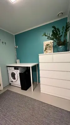 a laundry room with a white desk and a washing machine at Rustic Apartment in Bakklandet in Trondheim