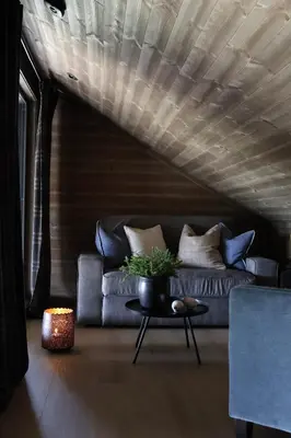 a living room with a couch and a table at New chalet with great view in Hafjell