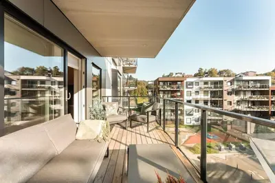 an apartment balcony with a view of a city at Luxury Apartment in Bergen, 10min from City Centre in Bergen
