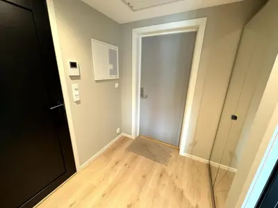 an empty room with a door and a wooden floor at Luxury Apartment in Bergen, 10min from City Centre in Bergen