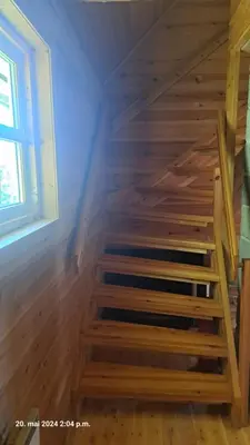 a wooden staircase in a room with a window at Kårhus på småbruk in Lia