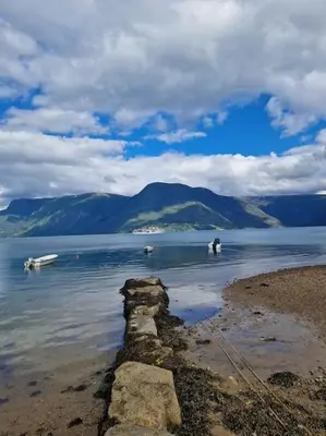 a group of boats in a large body of water at Feriehus ved fjorden i Solvorn in Luster