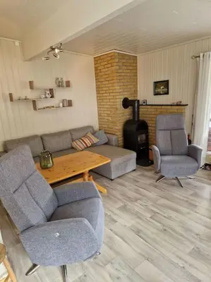 a living room with a couch and chairs and a table at Feriehus ved fjorden i Solvorn in Luster