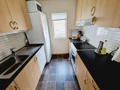a small kitchen with a sink and a stove at Feriehus ved fjorden i Solvorn in Luster