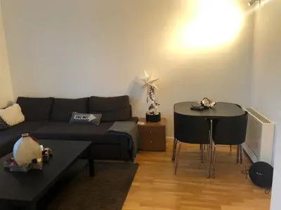 a living room with a couch and a table at Engen 6 in Bergen