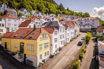 a row of houses on a city street at Leilighet i Bergens vakreste gate - Nydelig utsikt over innseilingen til Bergen! in Bergen