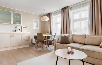 a living room with a couch and a table at Leilighet i Bergens vakreste gate - Nydelig utsikt over innseilingen til Bergen! in Bergen