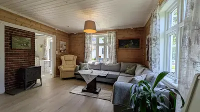 a living room with a couch and a table at Dønhaug Gjestegard in Uskedalen