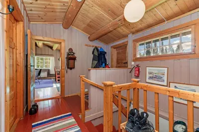 a staircase in a cabin with a wooden ceiling at Frøy&Frøya Hyttetun in Skammestein