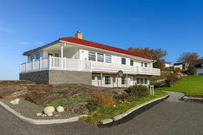 a large white house on top of a hill at Hus med panoramutsikt i Bud in Bud
