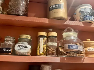 a shelf with jars of food on it at Vintage apartment with fresh sea air and pets in Kristiansund