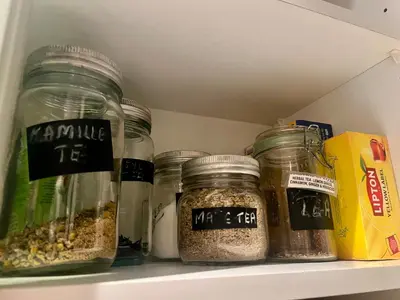 a pantry with jars of food on a shelf at Vintage apartment with fresh sea air and pets in Kristiansund