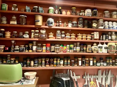 a shelf filled with lots of different types of jars at Vintage apartment with fresh sea air and pets in Kristiansund