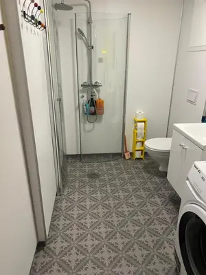 a bathroom with a shower and a toilet at Vintage apartment with fresh sea air and pets in Kristiansund