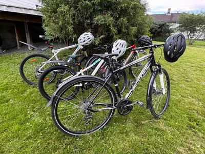 three bikes parked in the grass with helmets on them at Et helt hus i fredelige omgivelser med utsikt! ca 10 min fra Trondheim sentrum in Trondheim