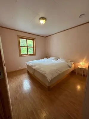 a bedroom with a large bed with a window at Hus med panorama utsikt in Måløy