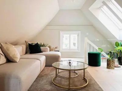 a living room with a couch and a glass table at Very Central Beautiful Modern Apartment in Bergen