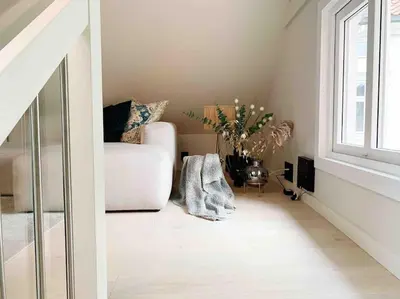 a living room with a chair and a window at Very Central Beautiful Modern Apartment in Bergen