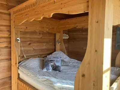 a wooden bunk bed in a log cabin at Rondane - Øvre Nordli Sollia Friluftsliv in Atnfoss