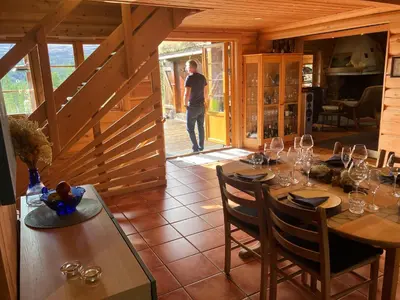 a man standing in a room with a table with wine glasses at Rondane - Øvre Nordli Sollia Friluftsliv in Atnfoss