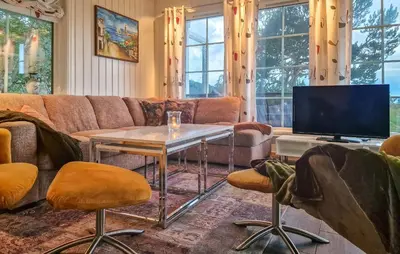 a living room with a couch and a tv at 2 Bedroom Nice Home In Skatval in Tilleraune