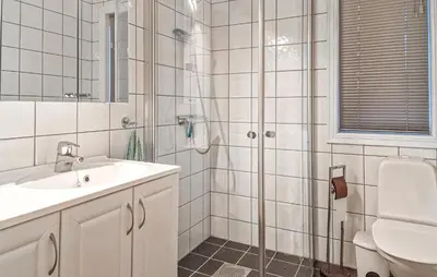 a white bathroom with a shower and a sink at 2 Bedroom Nice Home In Skatval in Tilleraune