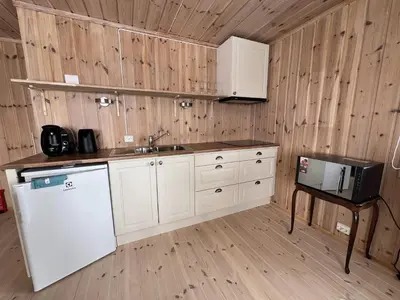 a kitchen with a white refrigerator and a sink at Perfect Couple's Hideaway In Nature! in Beitostøl
