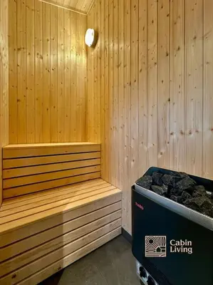 a sauna with a bench and a trash can at New large cabin with sauna in Hafjell in Nordseter