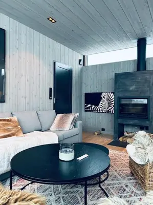 a living room with a couch and a coffee table at Eksklusiv hytte ved Fyri Resort - Utsikt in Hemsedal