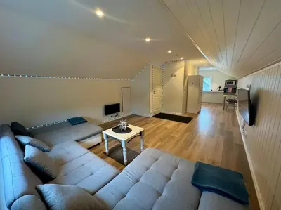 a living room with a couch and a table at Loft Apartment in Stranda