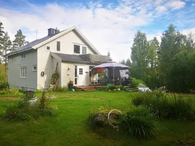a white house with a gazebo in a yard at Villa Ka Stor Elvdal in Koppang
