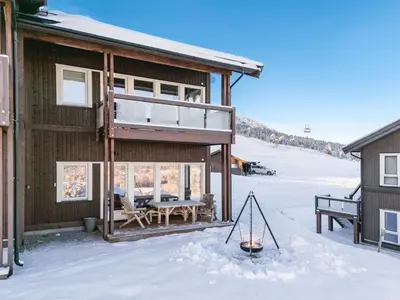 a house with a porch in the snow at Leilighet på Bualie, Golsfjellet in Gol